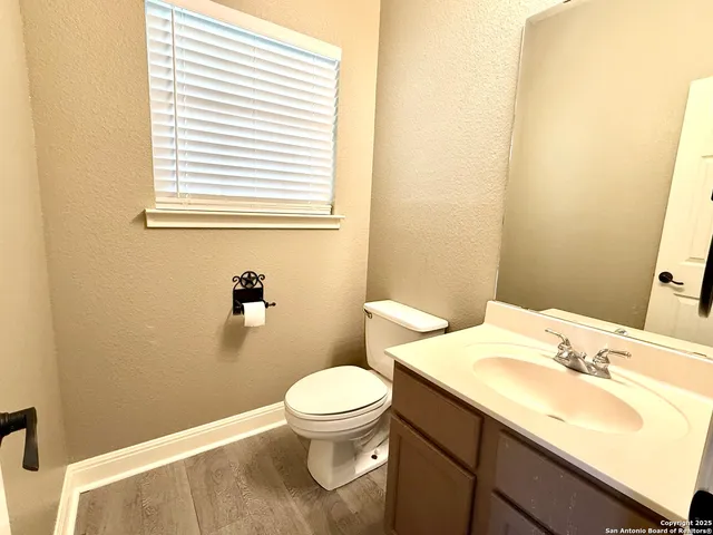 a bathroom with a sink a toilet and a mirror