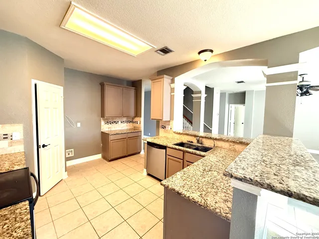 a kitchen with stainless steel appliances kitchen island granite countertop a sink and cabinets
