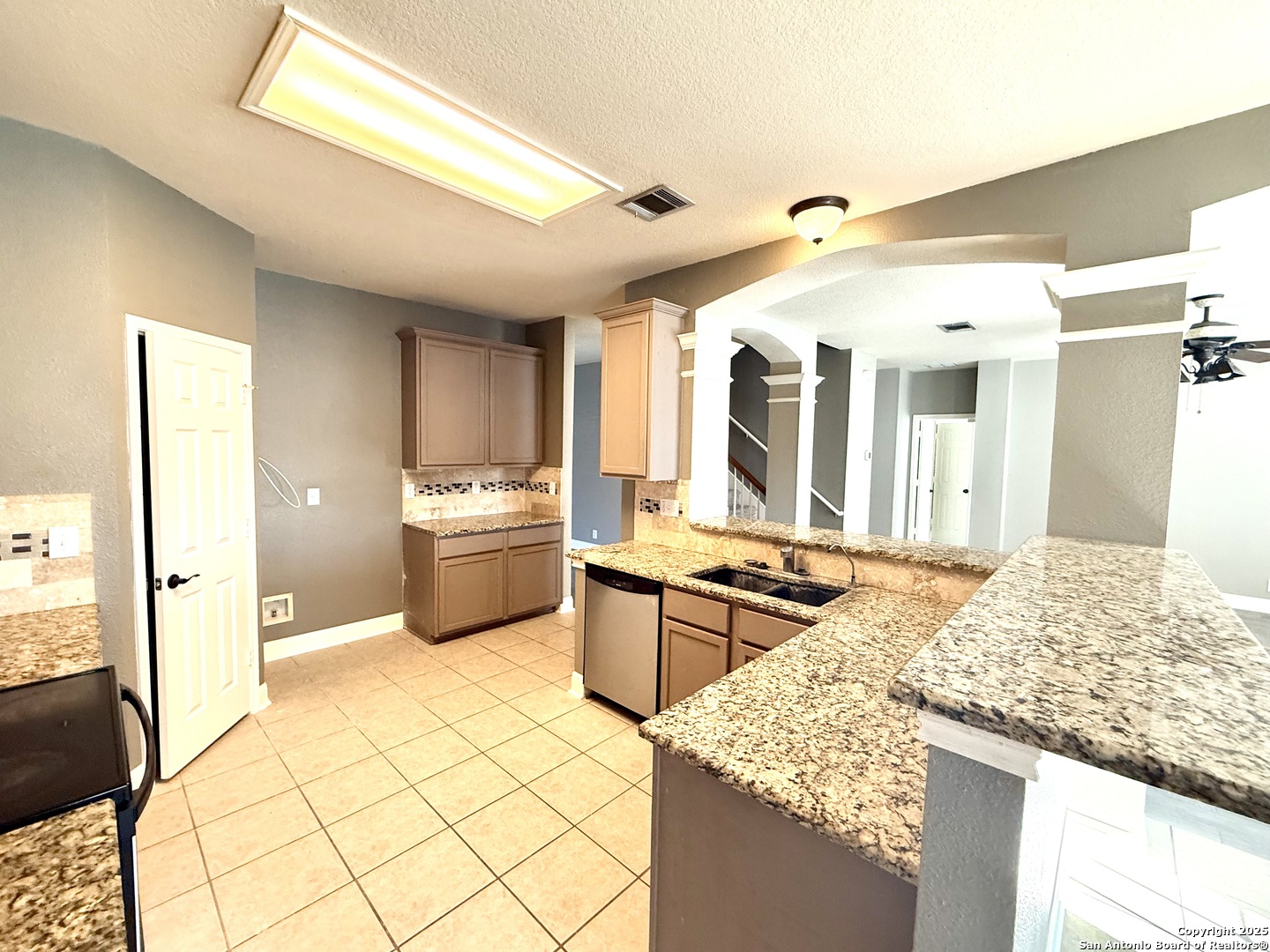 3526 Blackstone Run San Antonio, TX 78259 - Photo 6 of 18 a kitchen with stainless steel appliances kitchen island granite countertop a sink and cabinets
