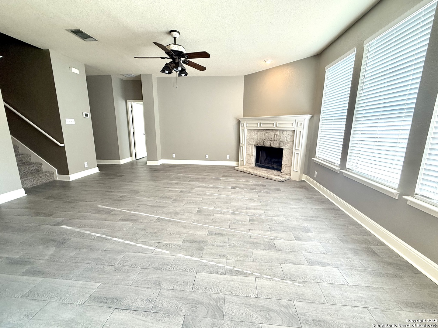 3526 Blackstone Run San Antonio, TX 78259 - Photo 8 of 18 a view of a livingroom with a fireplace a chandelier and windows