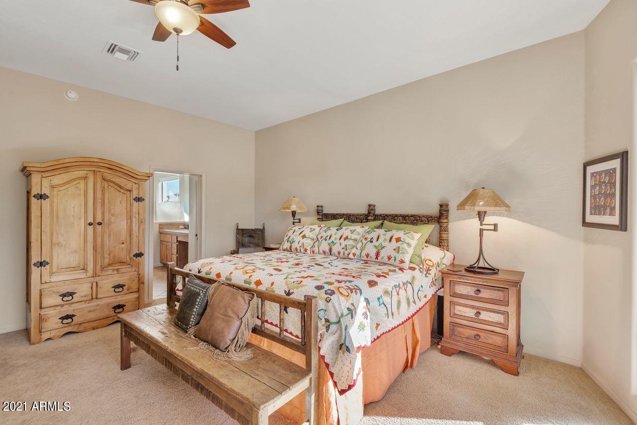 27802 North Quail Spring Road Rio Verde, AZ 85263 - Photo 11 of 35 a bedroom with a bed and a chandelier