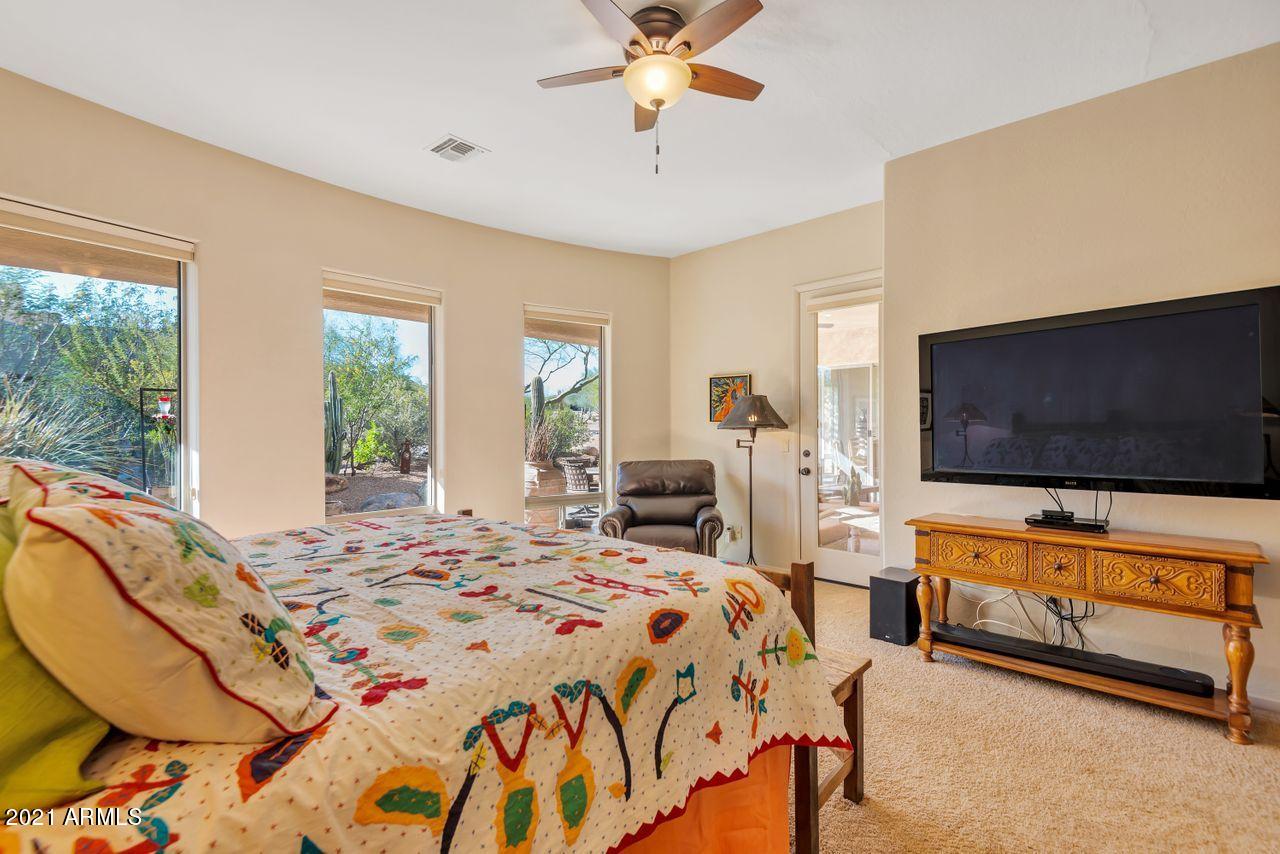 27802 North Quail Spring Road Rio Verde, AZ 85263 - Photo 13 of 35 a bedroom with a bed and glass windows