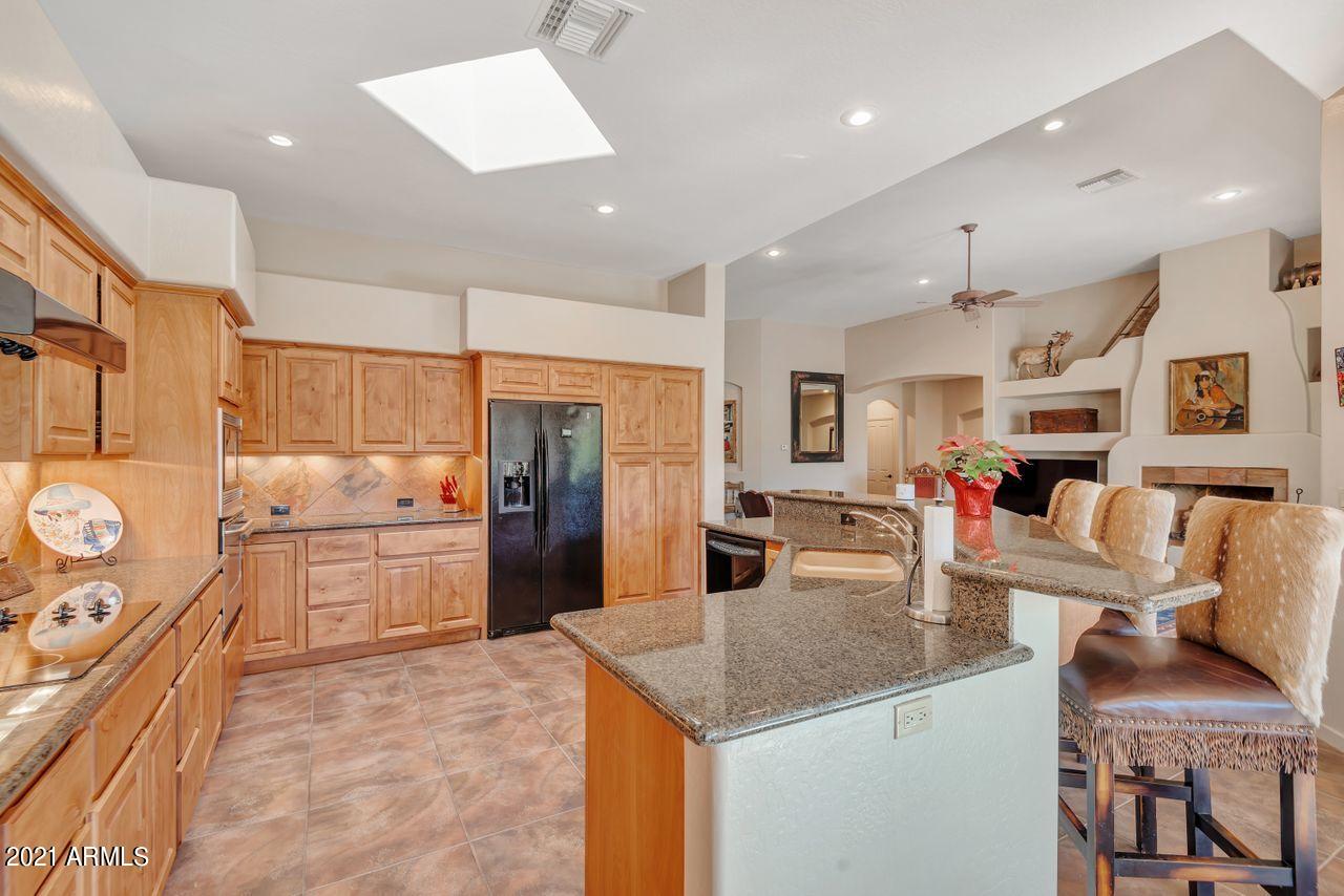 27802 North Quail Spring Road Rio Verde, AZ 85263 - Photo 23 of 35 a kitchen with stainless steel appliances granite countertop a sink refrigerator and cabinets