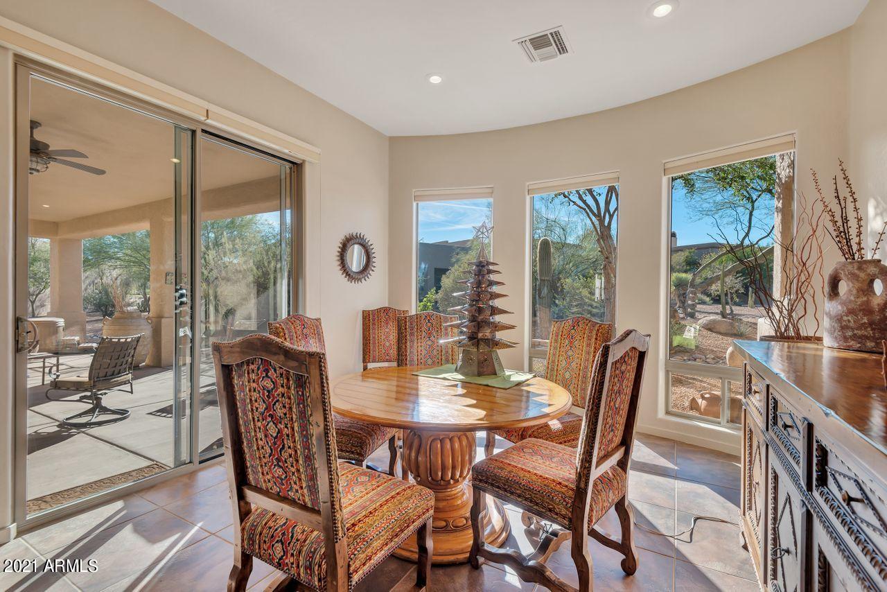 27802 North Quail Spring Road Rio Verde, AZ 85263 - Photo 28 of 35 a view of a dining room with furniture large windows and wooden floor