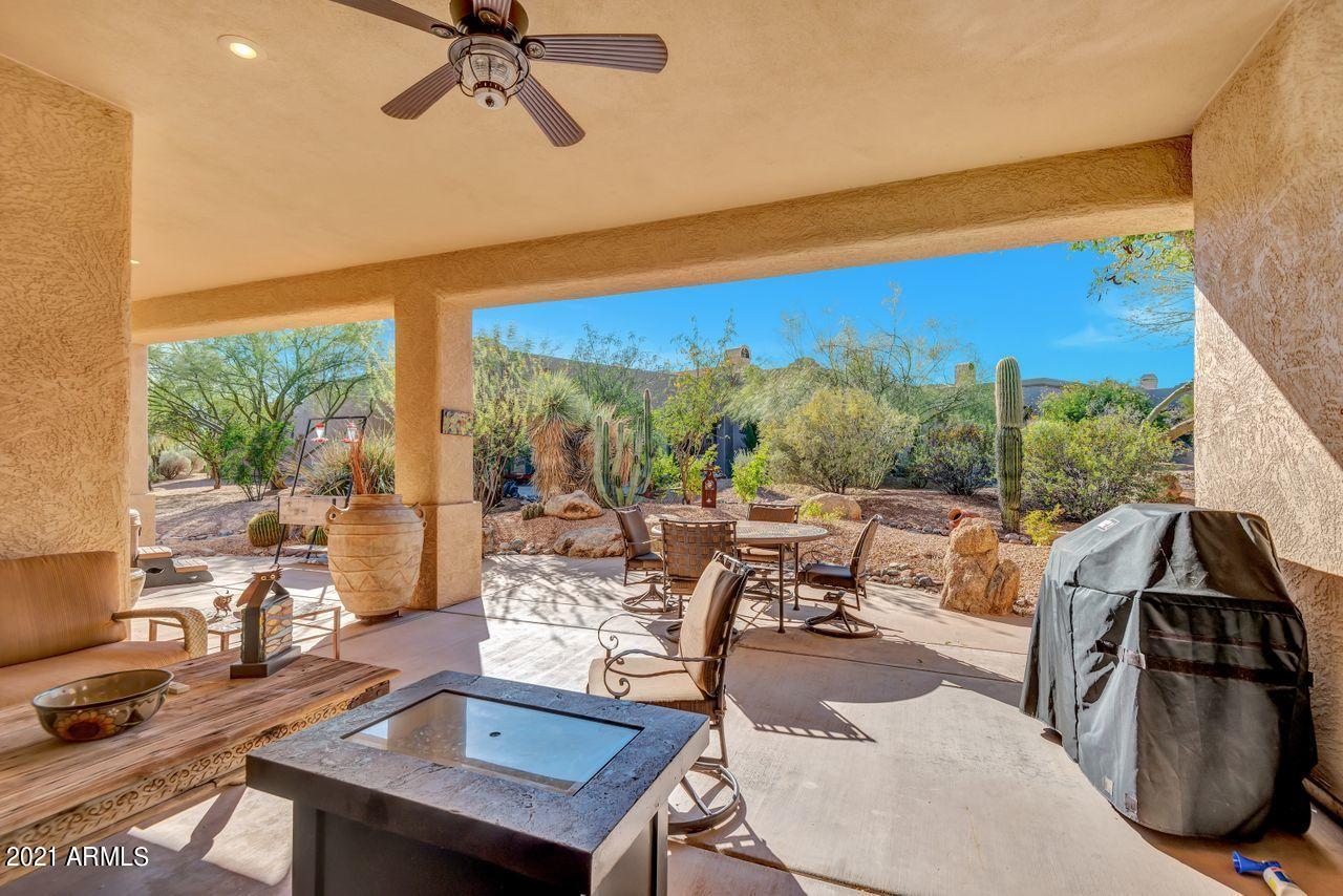 27802 North Quail Spring Road Rio Verde, AZ 85263 - Photo 6 of 35 a living room with patio furniture and a floor to ceiling window