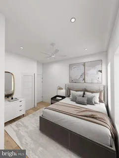 a bedroom with a large bed and a flat tv screen on dresser