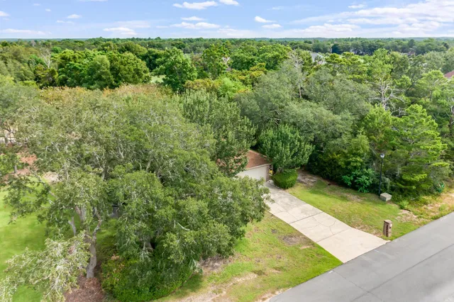 a kitchen with stainless steel appliances granite countertop a sink a stove and a wooden cabinets