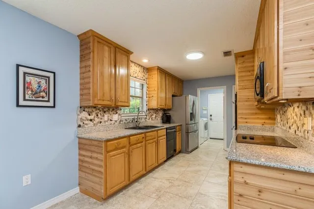 a bathroom with a granite countertop sink a mirror and toilet