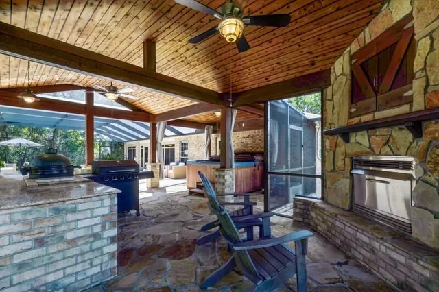 a living room with furniture a ceiling fan and a rug