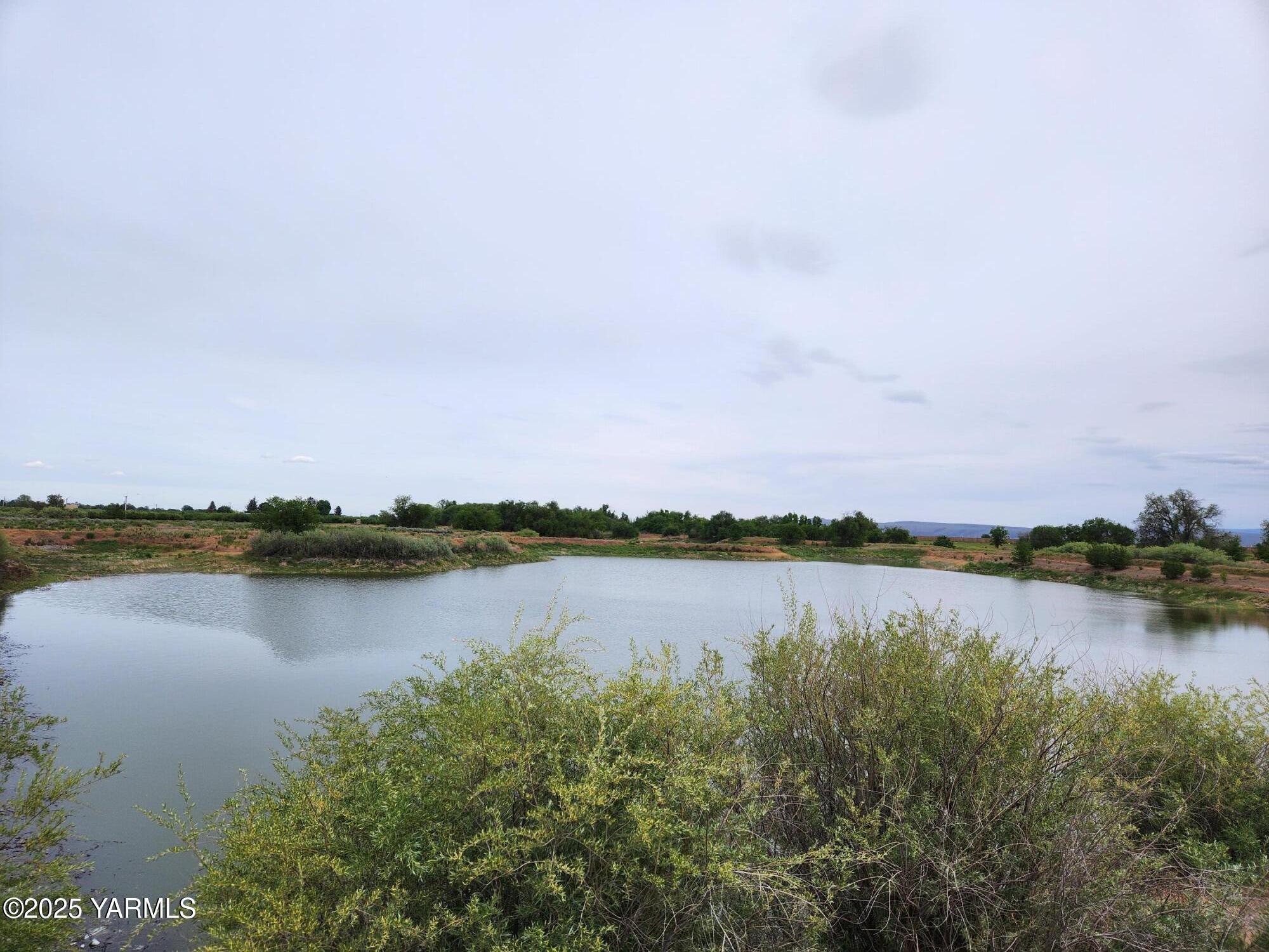 Nka Progressive Road Wapato, WA 98951 - Photo 1 of 6 a view of a lake with houses in the back