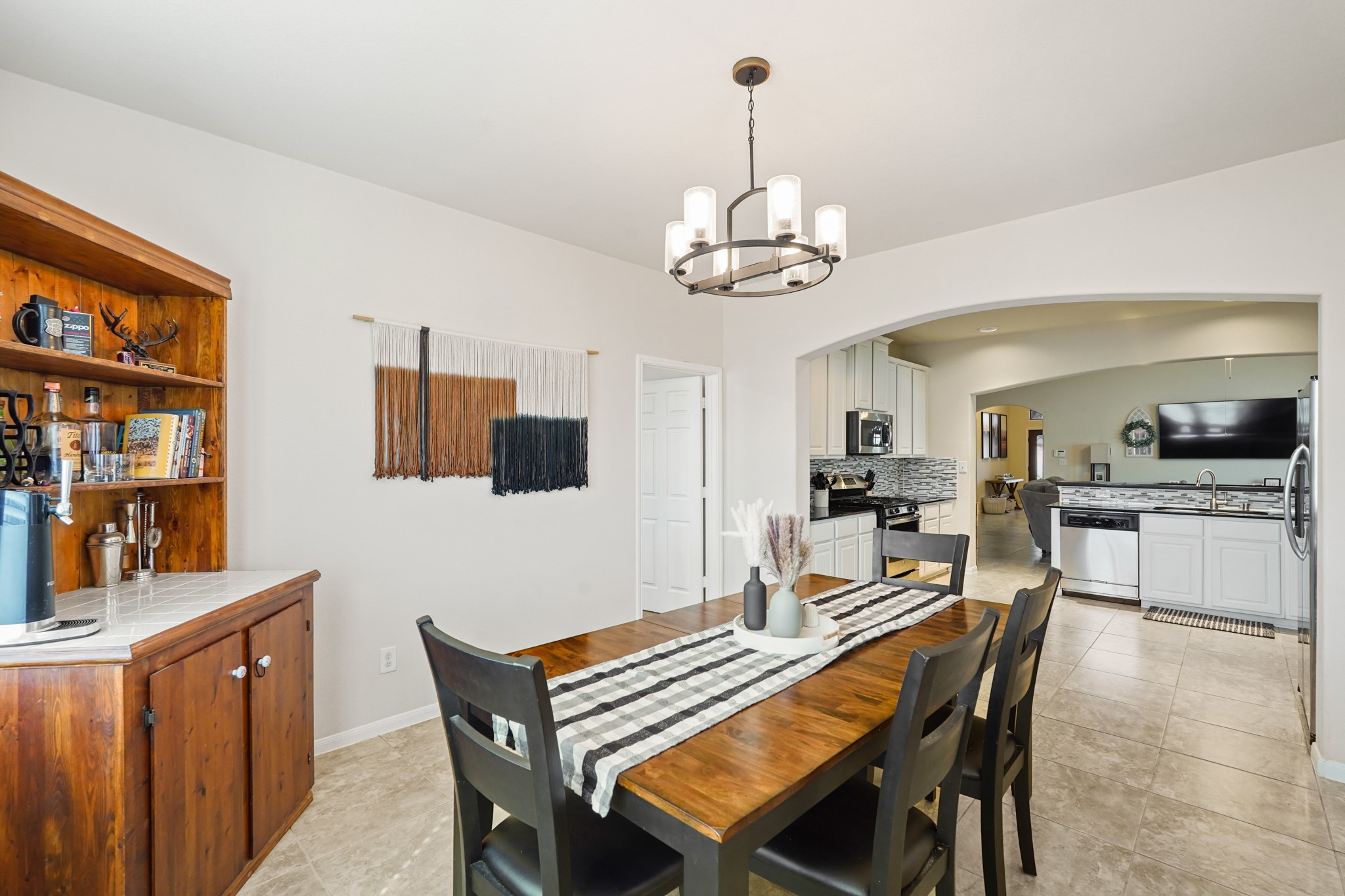 2027 Wembley Way Rosenberg, TX 77471 - Photo 16 of 28 a view of a dining room with furniture a kitchen and chandelier