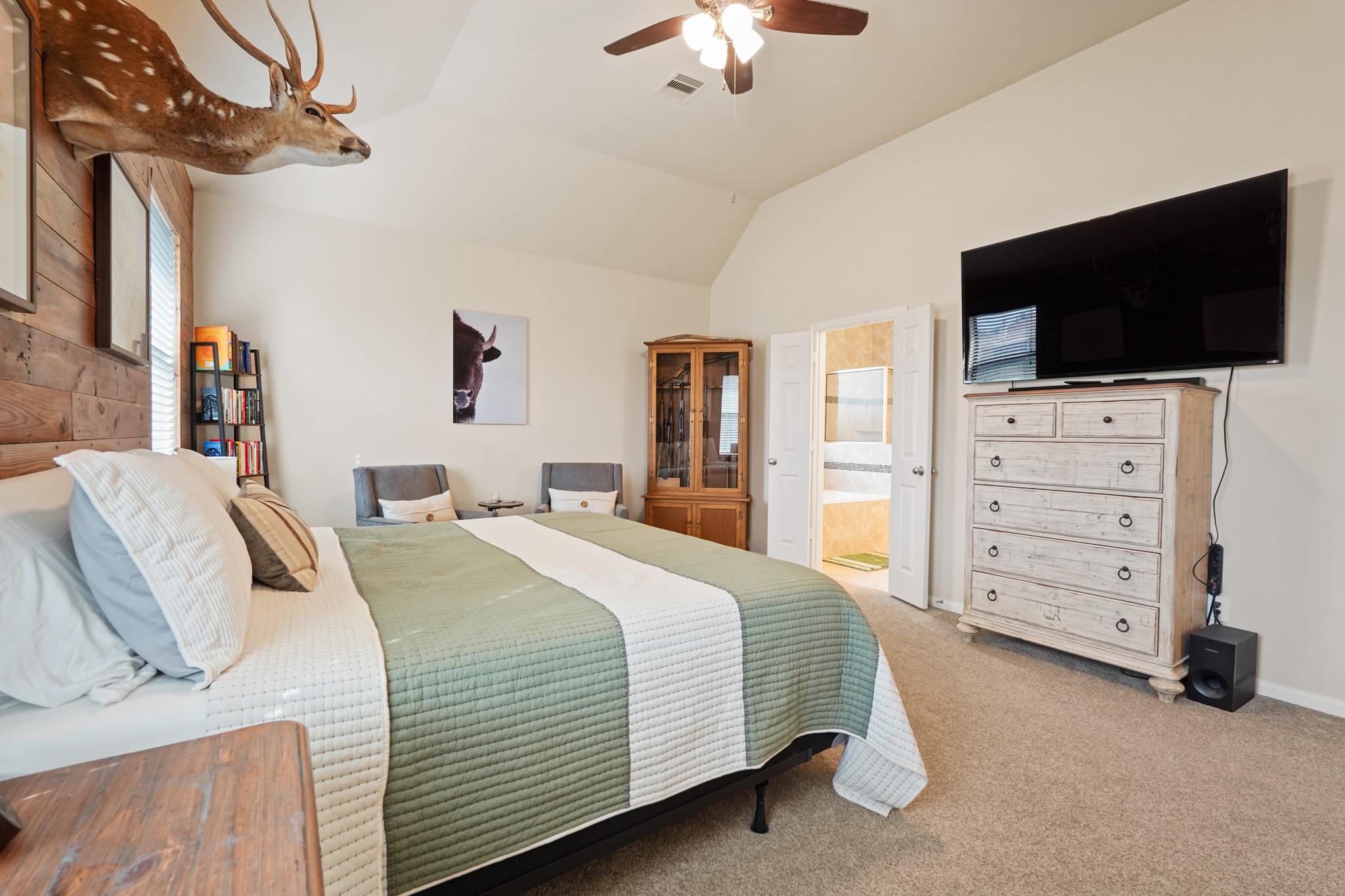 2027 Wembley Way Rosenberg, TX 77471 - Photo 18 of 28 a bedroom with a bed a flat tv screen and a chandelier