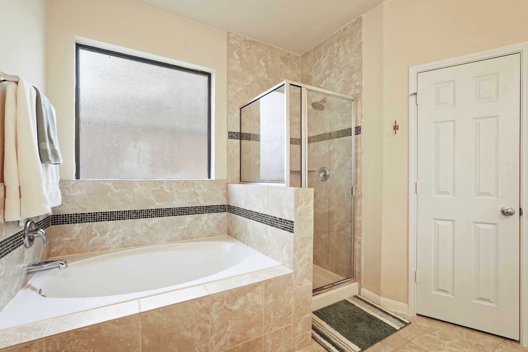 2027 Wembley Way Rosenberg, TX 77471 - Photo 20 of 28 a bathroom with a bathtub and a shower