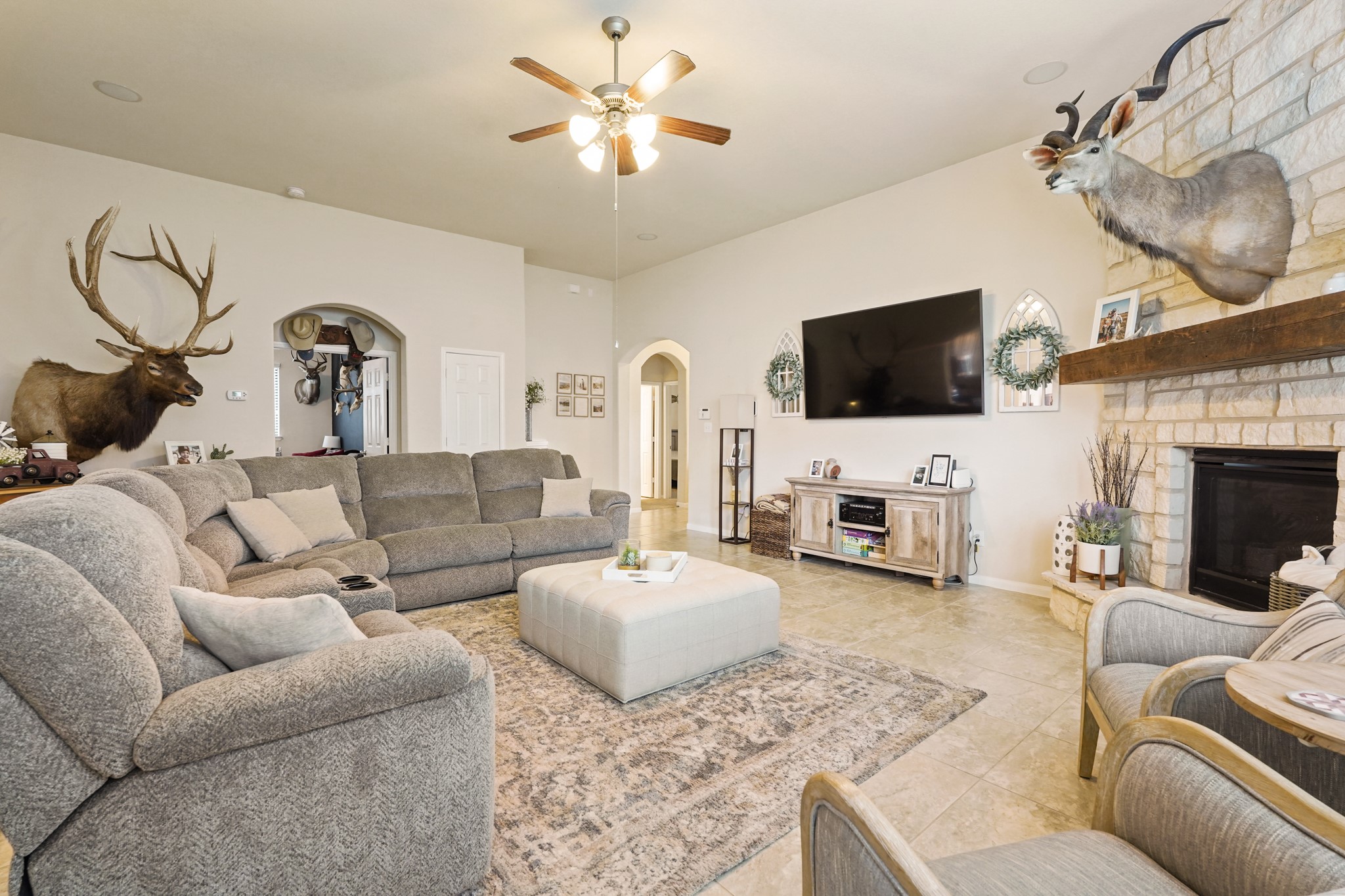 2027 Wembley Way Rosenberg, TX 77471 - Photo 10 of 28 a living room with furniture a flat screen tv and a fireplace