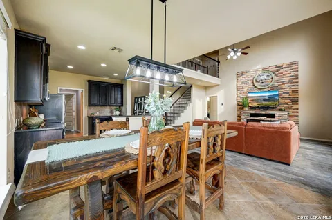 a dining room with furniture and wooden floor