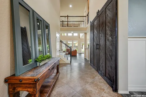 a view of a hallway with wooden floor and windows