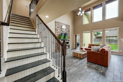 a living room with furniture and stairs