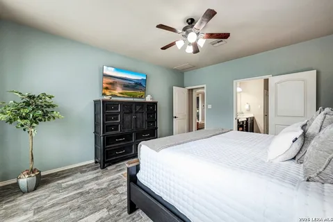 a bedroom with a bed and a television