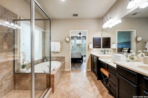 a spacious bathroom with a sink double vanity and mirror