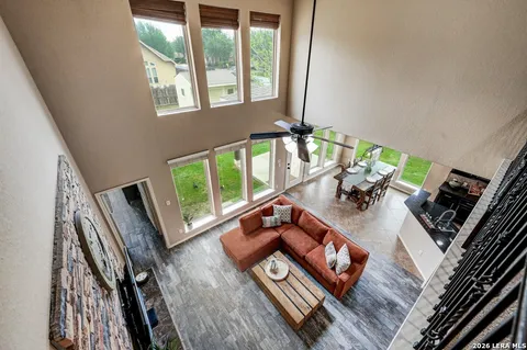 a living room with furniture and a floor to ceiling window