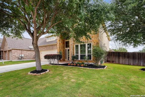 a front view of a house with a yard table and chairs