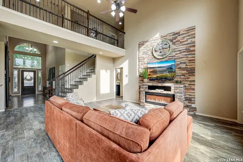 a living room with furniture and a chandelier