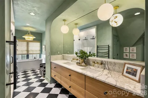 a spacious bathroom with a granite countertop sink mirror and bathtub