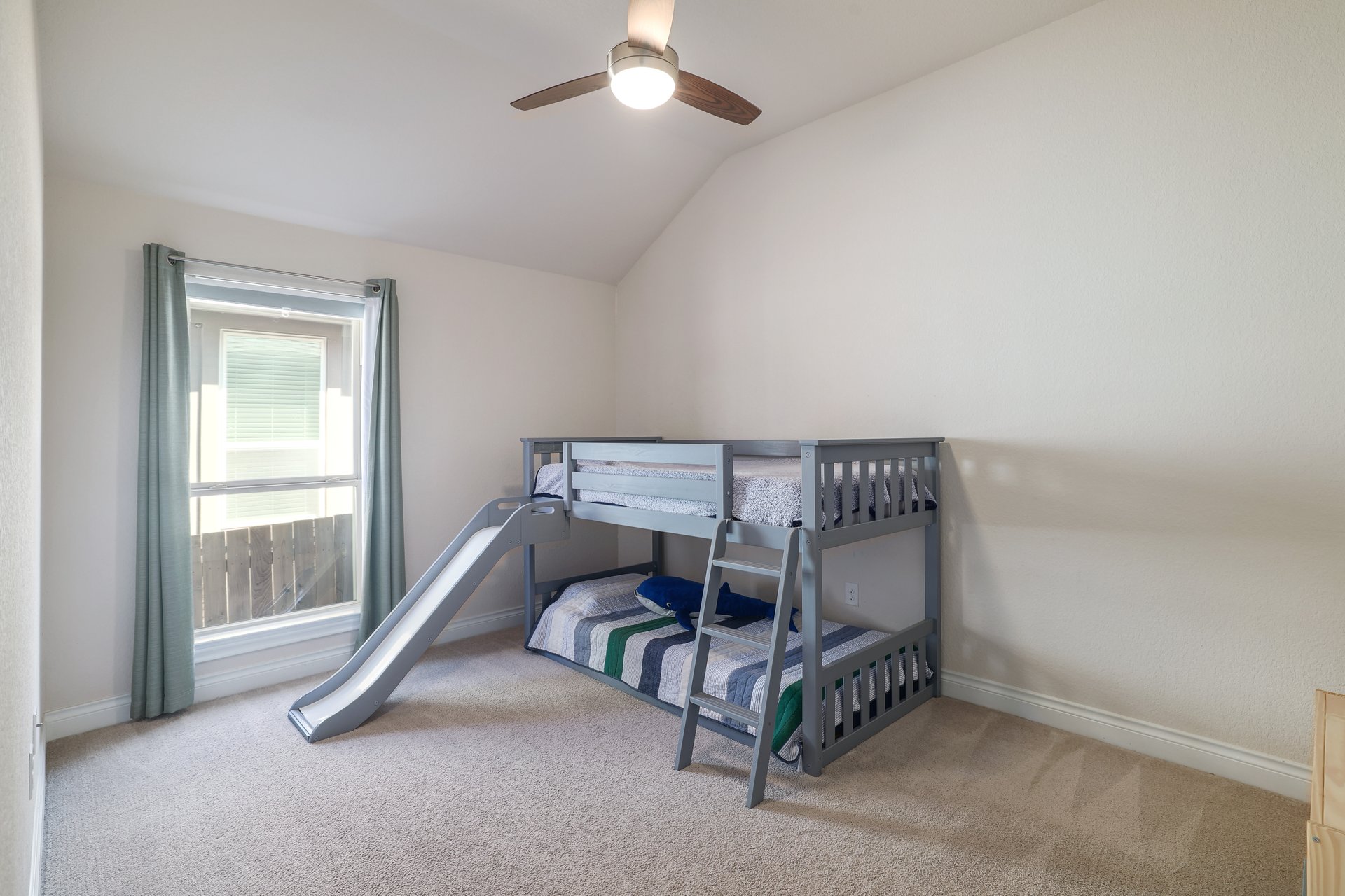 173 Santa Maria Street Georgetown, TX 78628 - Photo 29 of 39 Bedroom 4 with a vaulted ceiling and a ceiling fan with light fixture