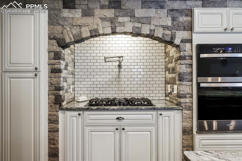 6940 Franciville Road Colorado Springs, CO 80908 - Photo 12 of 40 a bathroom with a granite countertop sink and a stove