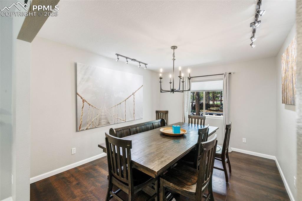 6940 Franciville Road Colorado Springs, CO 80908 - Photo 15 of 40 a view of a dining room with furniture and wooden floor