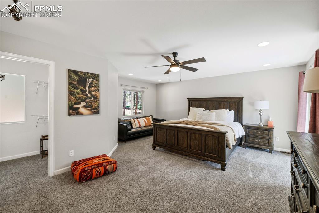 6940 Franciville Road Colorado Springs, CO 80908 - Photo 16 of 40 a bedroom with a bed and a chandelier