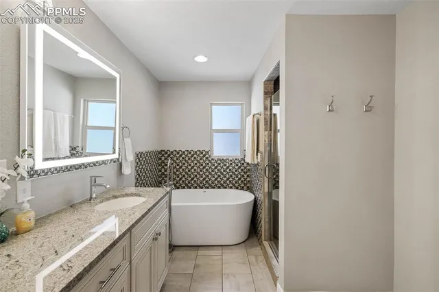 a bathroom with a granite countertop sink toilet and shower
