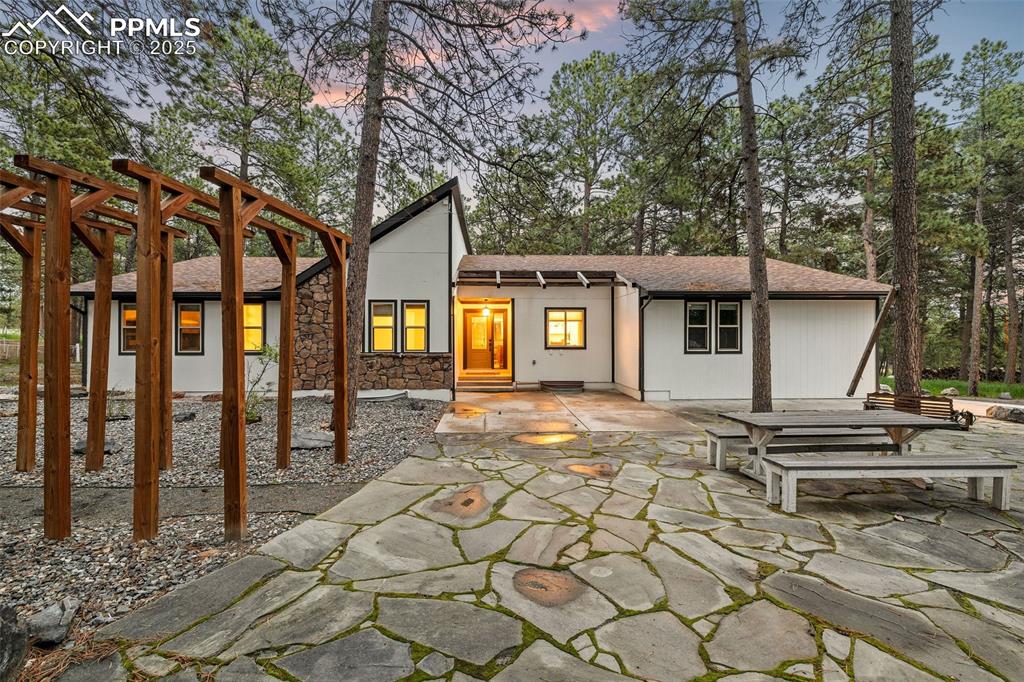 6940 Franciville Road Colorado Springs, CO 80908 - Photo 2 of 40 a view of a house with a tree and wooden fence