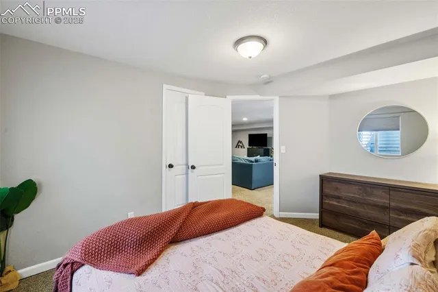 a bedroom with a bed and a lamp with the wooden floor