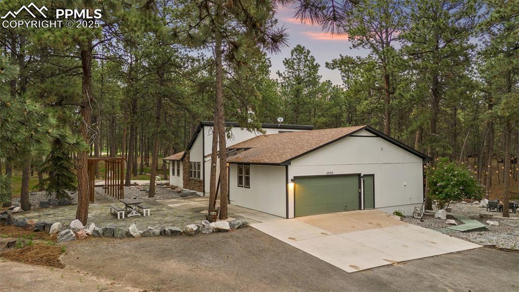 6940 Franciville Road Colorado Springs, CO 80908 - Photo 32 of 40 a view of a house with a yard and large tree