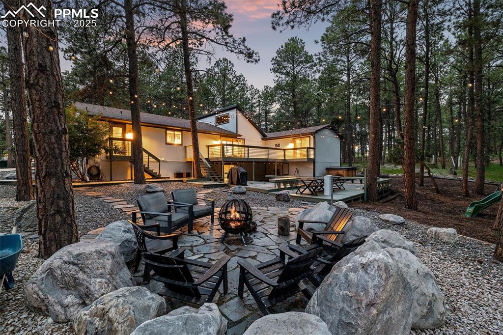 6940 Franciville Road Colorado Springs, CO 80908 - Photo 34 of 40 a view of a patio with table and chairs and potted plants