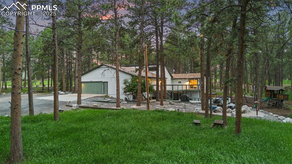 6940 Franciville Road Colorado Springs, CO 80908 - Photo 37 of 40 a house view with a sitting space and garden