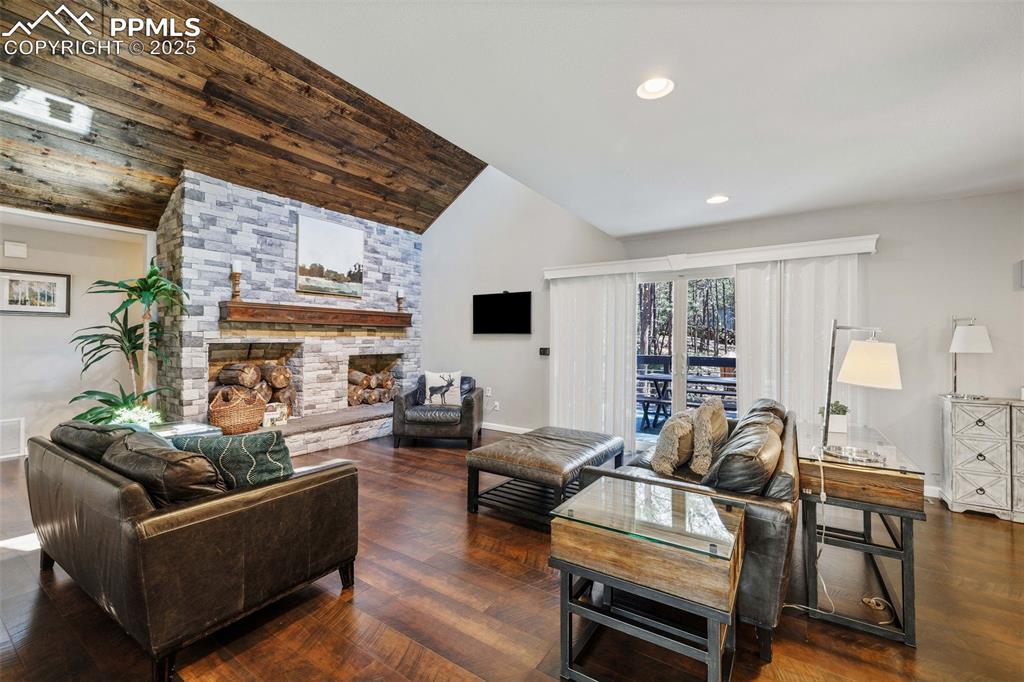 6940 Franciville Road Colorado Springs, CO 80908 - Photo 5 of 40 a living room with furniture a fireplace and a flat screen tv