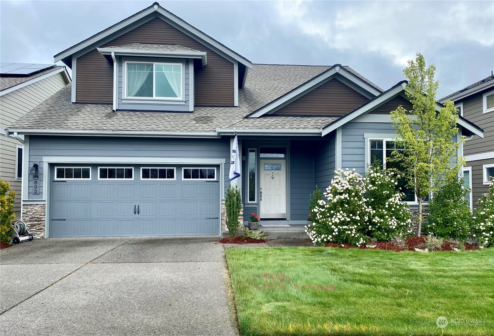 a front view of a house with a yard and garage