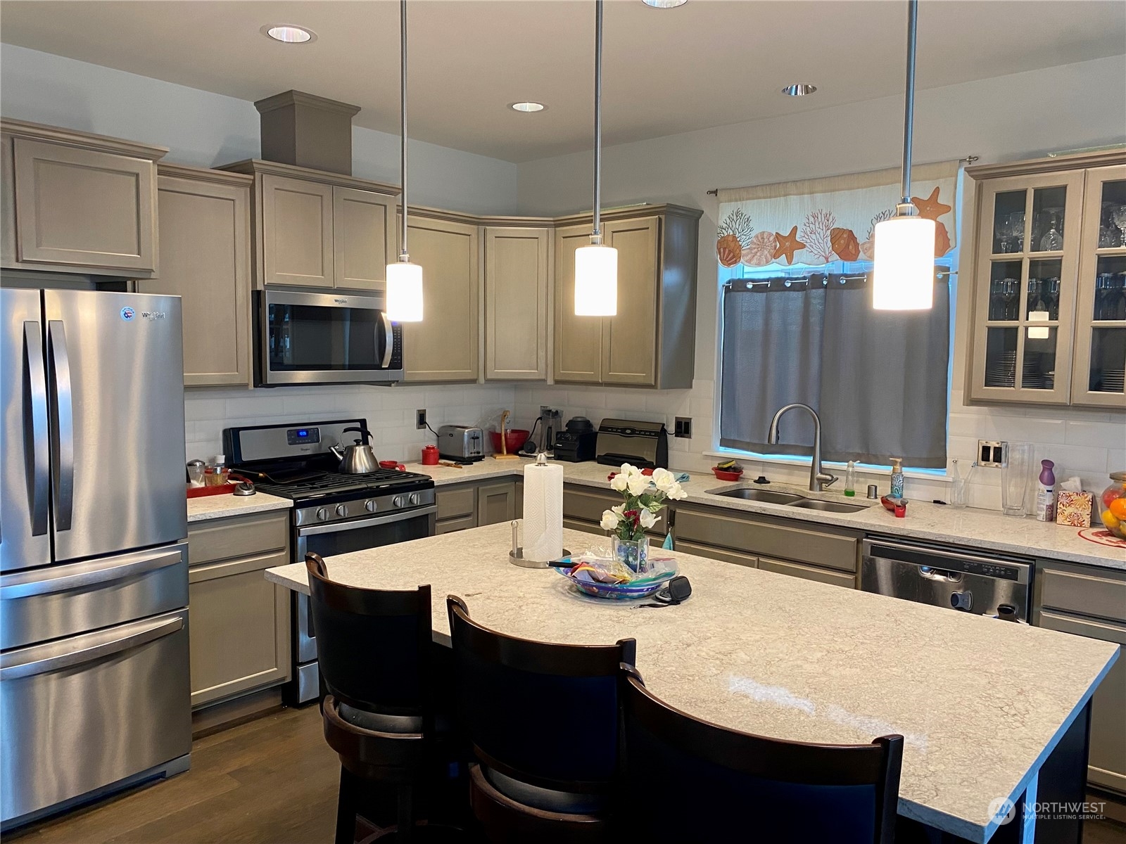 802 Mandee Street Southeast Lacey, WA 98513 - Photo 11 of 28 a kitchen with a sink a stove a refrigerator and chairs