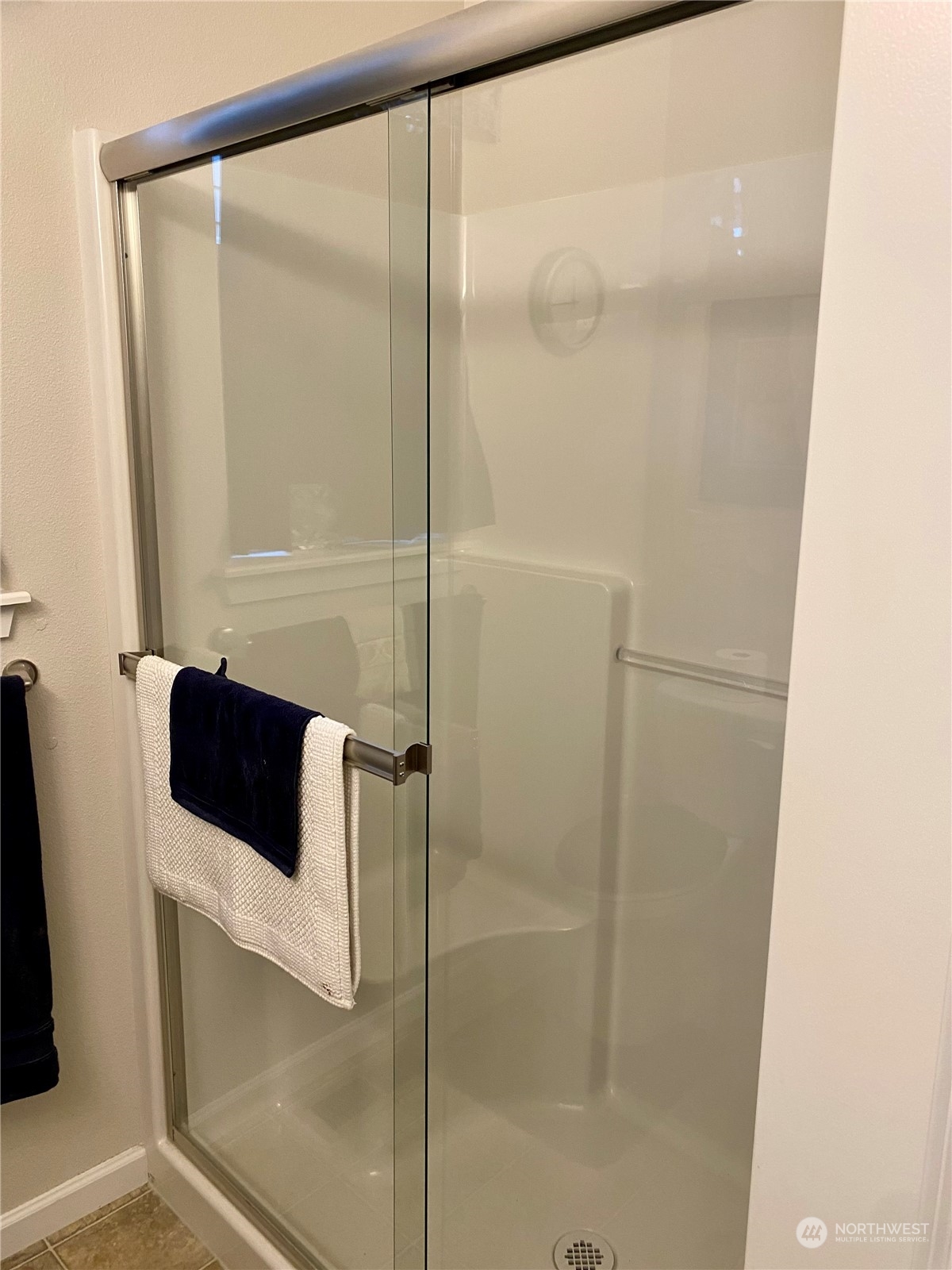 802 Mandee Street Southeast Lacey, WA 98513 - Photo 18 of 28 a bathroom with a glass shower door