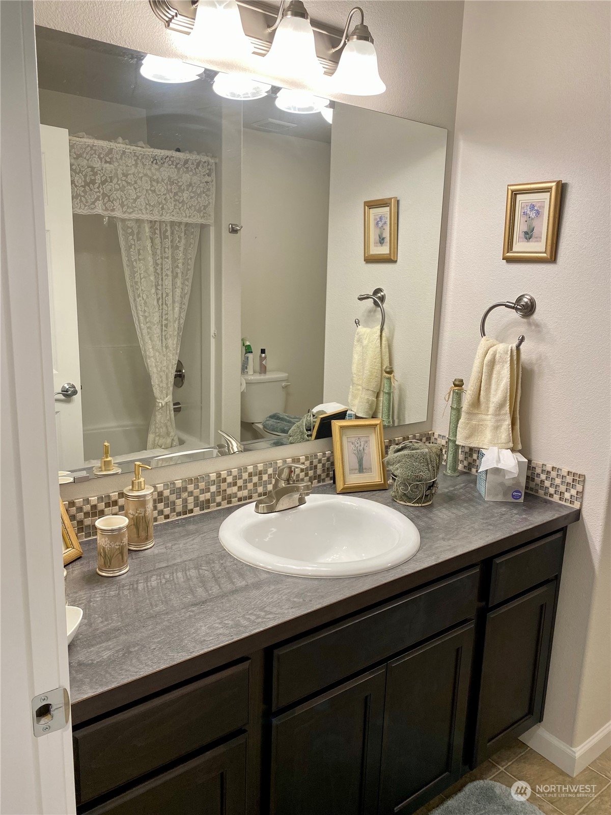 802 Mandee Street Southeast Lacey, WA 98513 - Photo 25 of 28 a bathroom with a granite countertop sink and a mirror