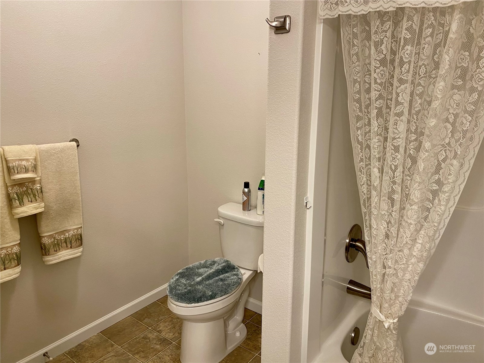 802 Mandee Street Southeast Lacey, WA 98513 - Photo 26 of 28 a bathroom with a toilet and shower curtain