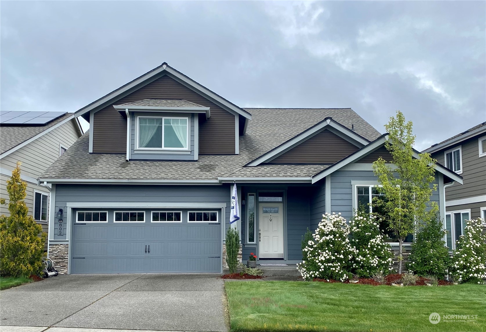 802 Mandee Street Southeast Lacey, WA 98513 - Photo 28 of 28 a front view of a house with a yard and garage