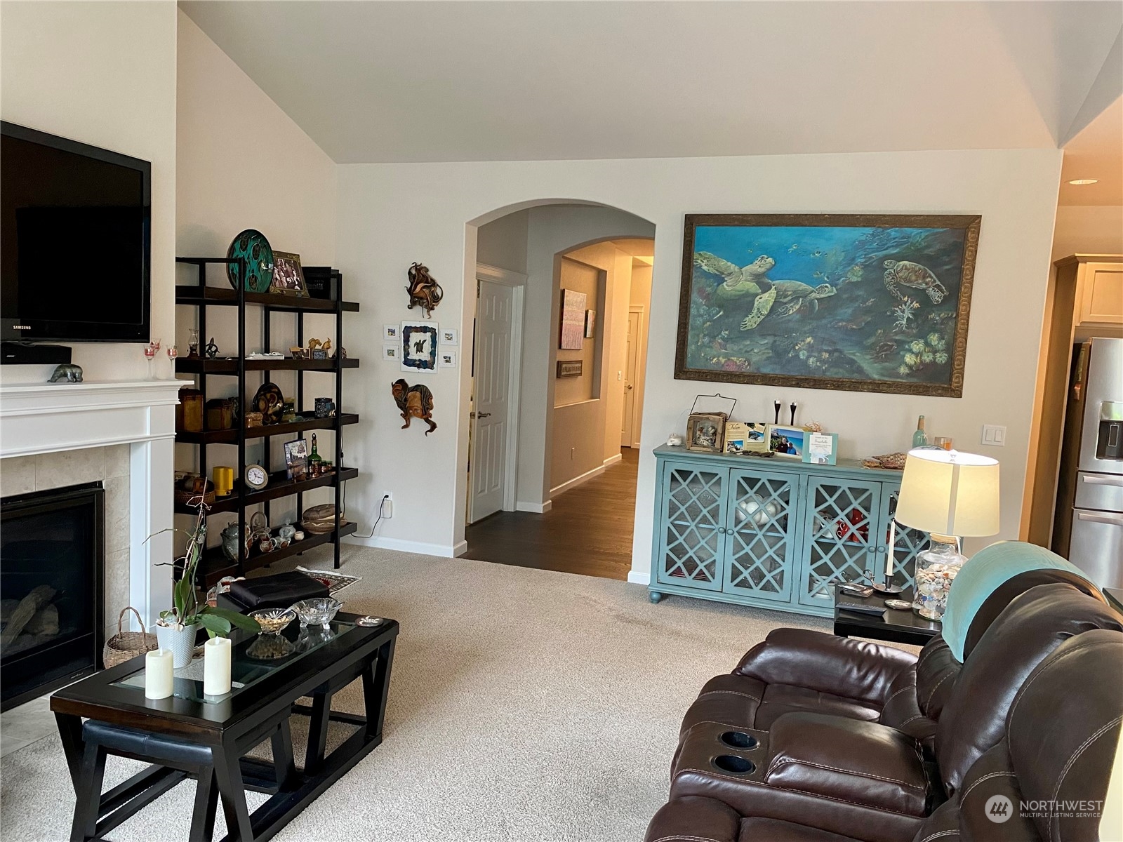 802 Mandee Street Southeast Lacey, WA 98513 - Photo 4 of 28 a living room with furniture a flat screen tv and a fireplace