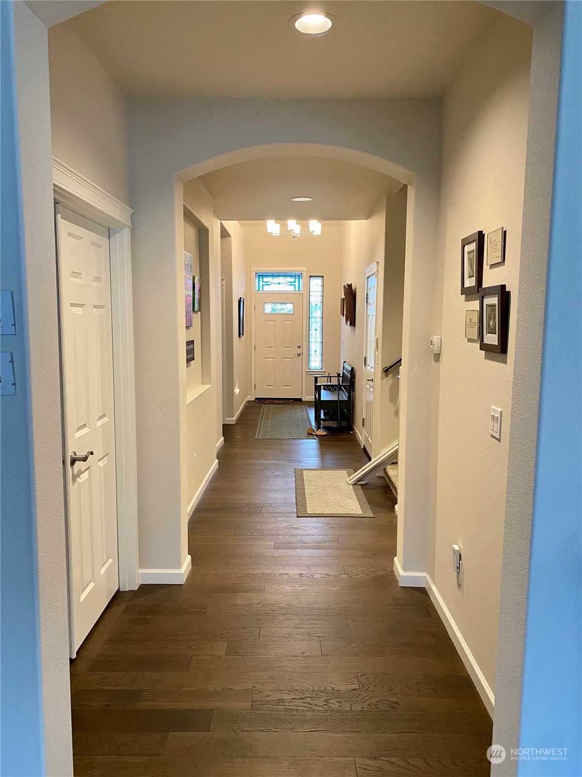 802 Mandee Street Southeast Lacey, WA 98513 - Photo 7 of 28 a view of a hallway with wooden floor and a living room