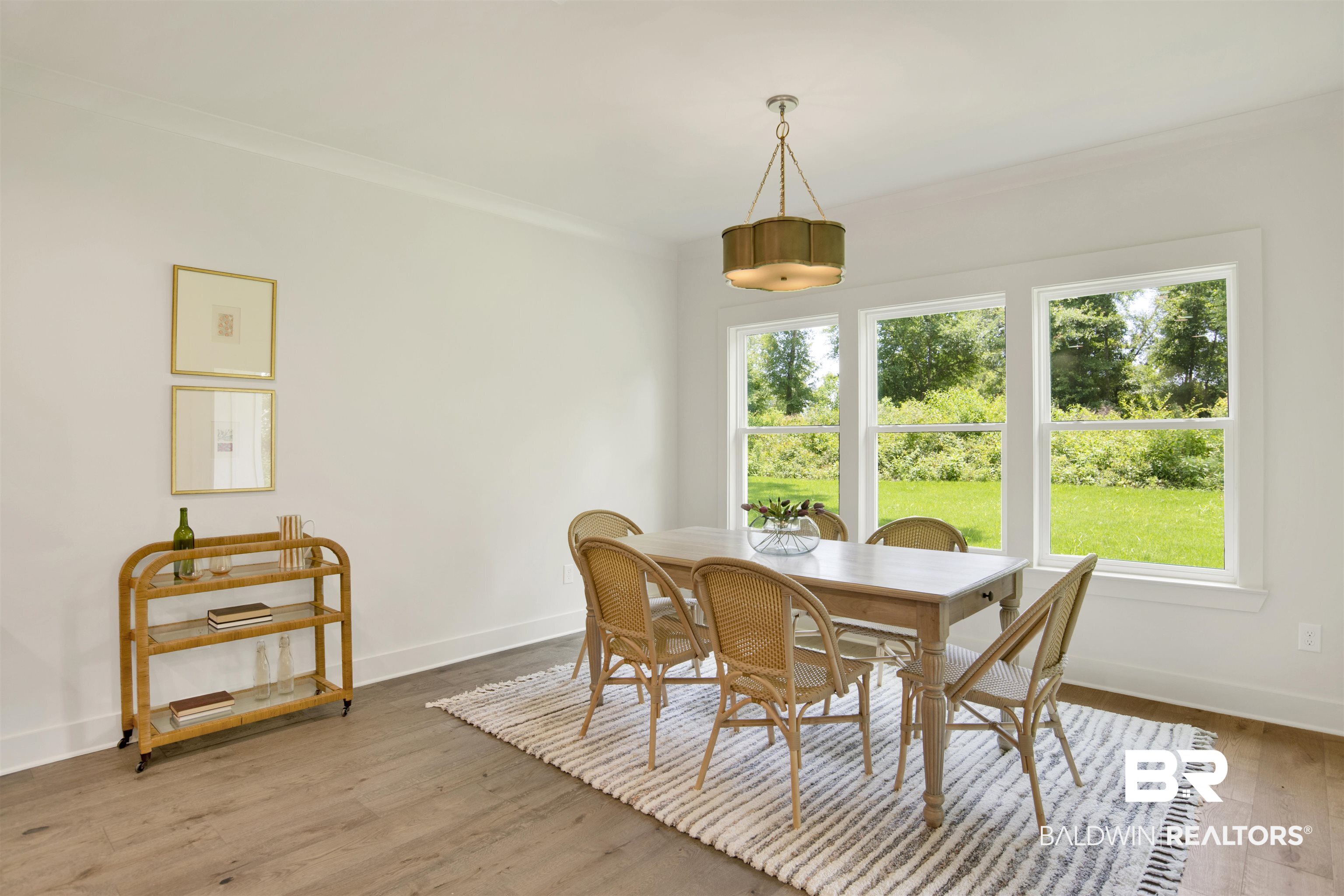 9275 Clarke Ridge Road Foley, AL 36535 - Photo 19 of 43 Dining space with plenty of natural light, baseboards, crown molding, and wood finished floors
