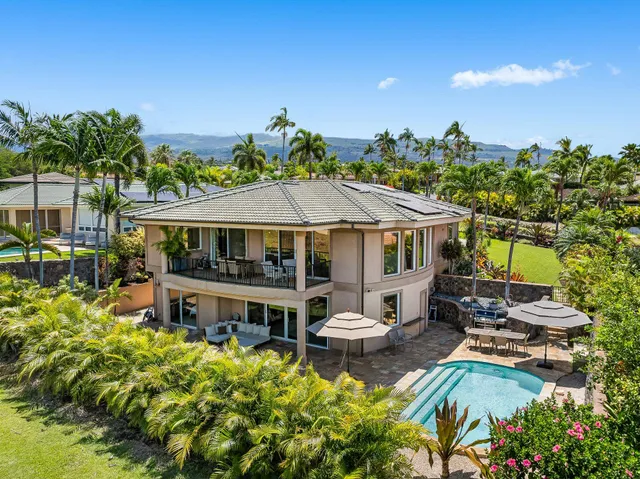 a aerial view of a house with swimming pool garden and patio