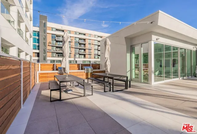 a view of a swimming pool with outdoor seating