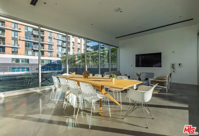 a living room with furniture and a floor to ceiling window